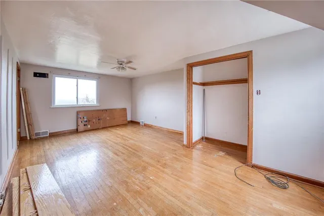 a view of a room with wooden floor and windows