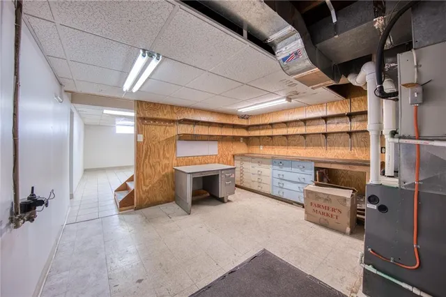 a view of a hallway with wooden cabinets