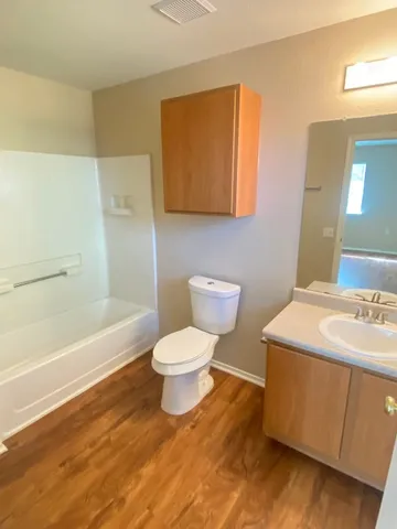 a bathroom with a sink a toilet and bathtub
