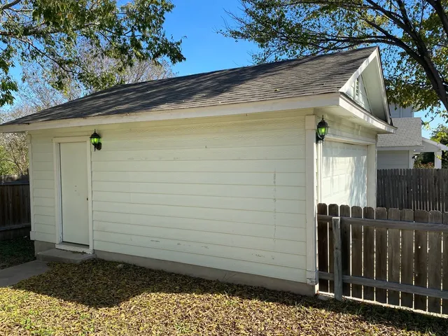 a view of a house with a wooden fence