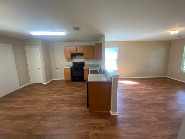 a kitchen with kitchen island microwave and stove top oven