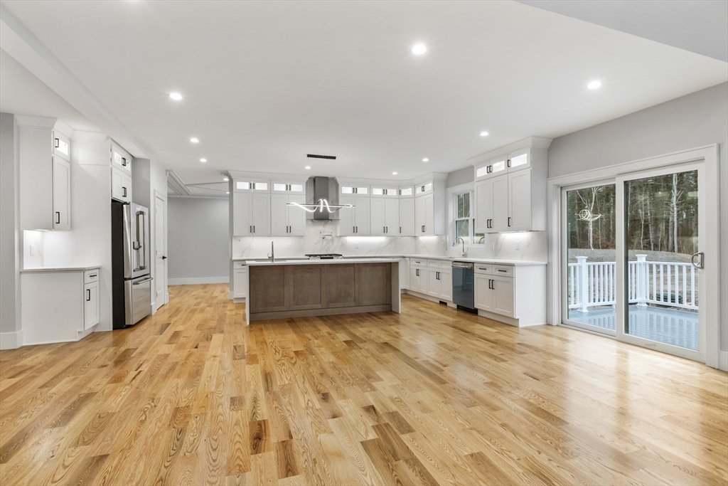 102 Pine Street Norton, MA 02766 - Photo 13 of 41 a large kitchen with stainless steel appliances kitchen island a large counter top a stove and a sink