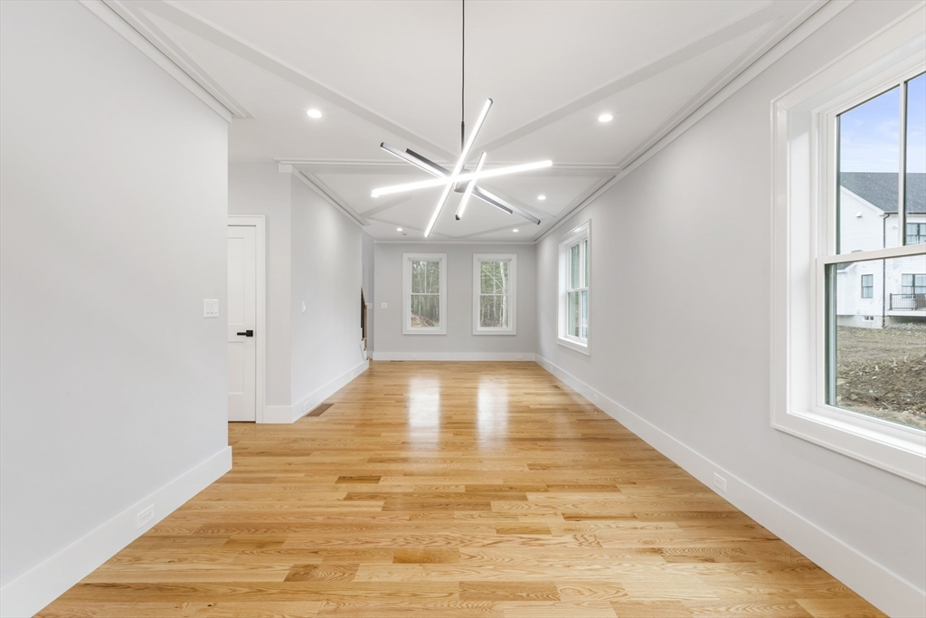 102 Pine Street Norton, MA 02766 - Photo 16 of 41 a view of an empty room with window and wooden floor