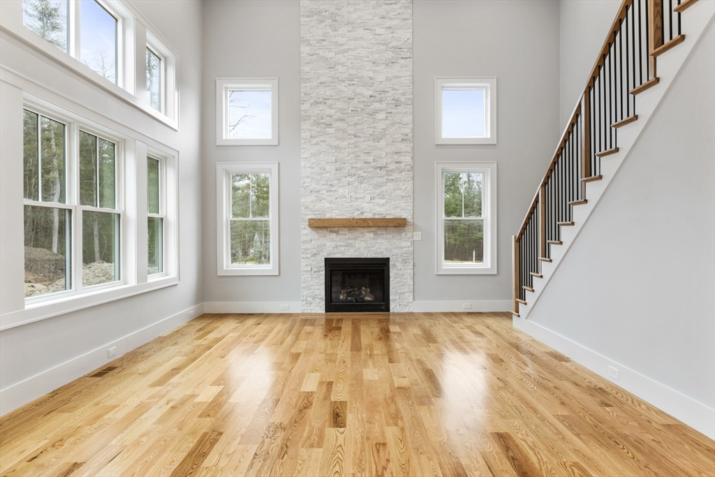102 Pine Street Norton, MA 02766 - Photo 3 of 41 a view of an empty room with wooden floor fireplace and a window