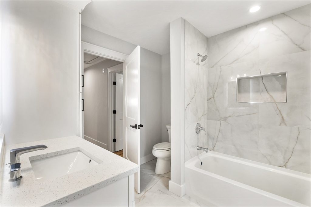 102 Pine Street Norton, MA 02766 - Photo 35 of 41 a bathroom with a tub sink toilet and a mirror