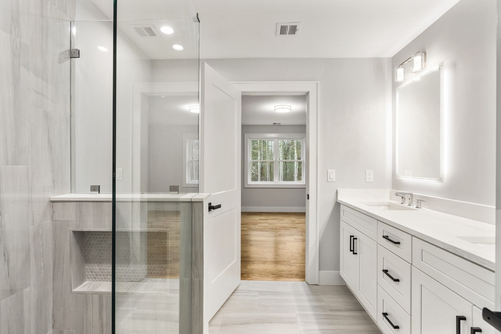 102 Pine Street Norton, MA 02766 - Photo 39 of 41 a bathroom with a double vanity sink a mirror and a shower