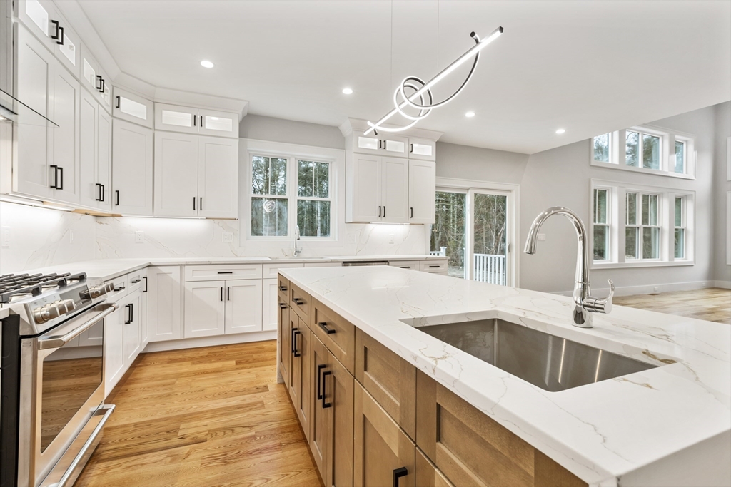 102 Pine Street Norton, MA 02766 - Photo 9 of 41 a kitchen with granite countertop a sink and white cabinets