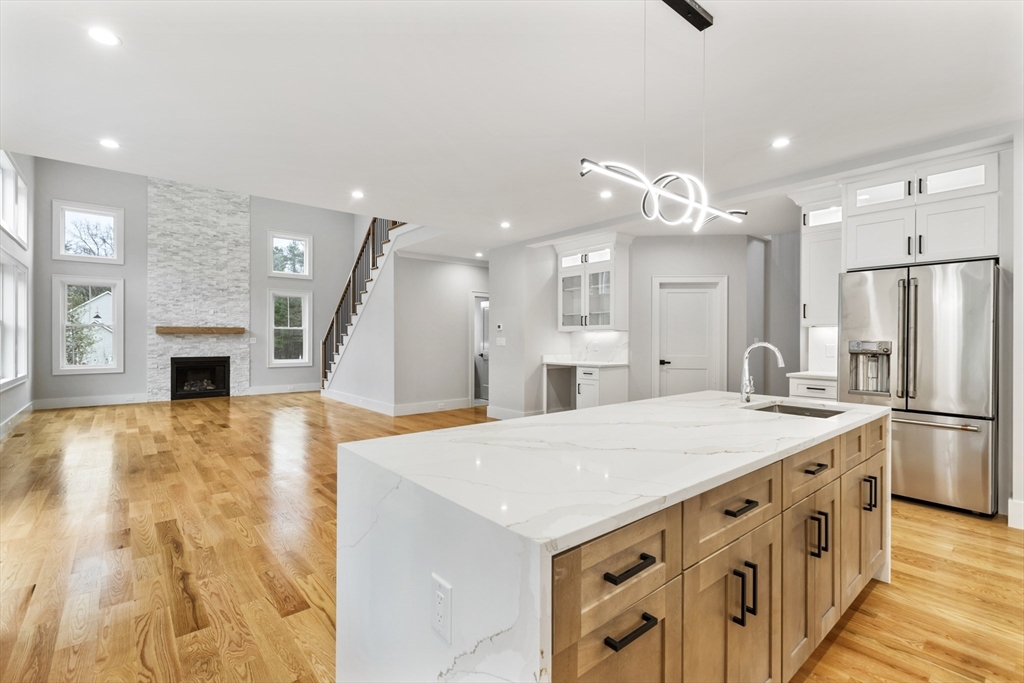 102 Pine Street Norton, MA 02766 - Photo 10 of 41 a kitchen with stainless steel appliances kitchen island a refrigerator sink and fireplace