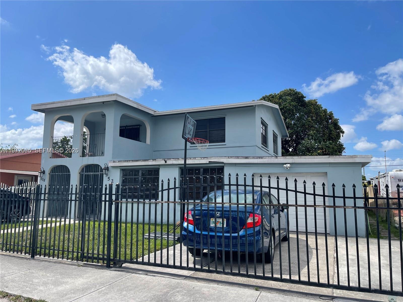 952 East 19th Street Hialeah, FL 33013 - Photo 1 of 13 a view of a white house with large windows and a flower plants