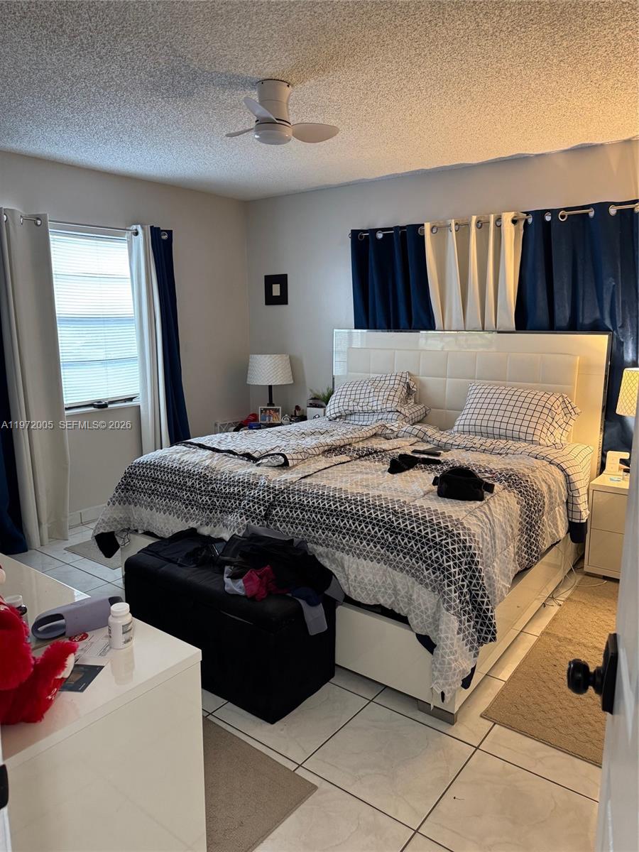 952 East 19th Street Hialeah, FL 33013 - Photo 4 of 13 a bedroom with a bed and a large mirror