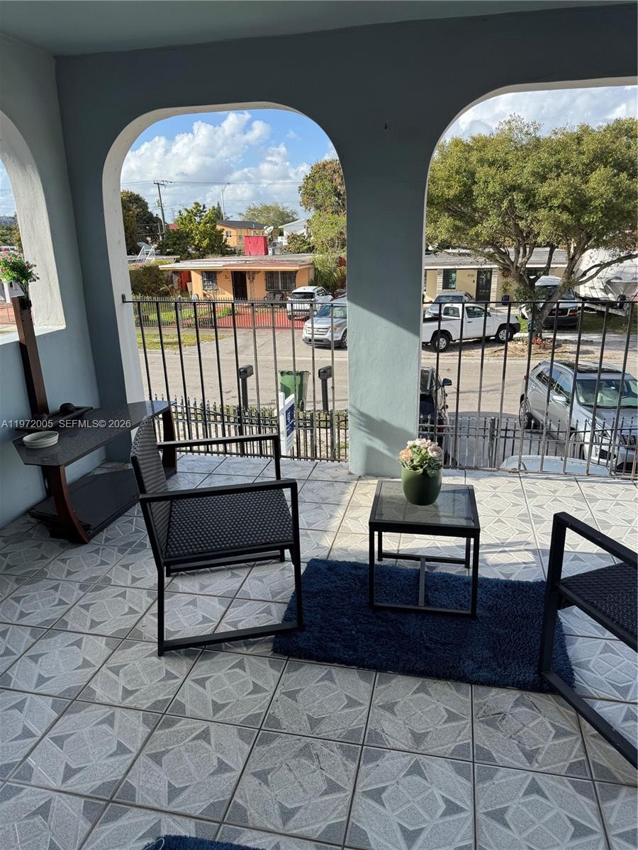 952 East 19th Street Hialeah, FL 33013 - Photo 8 of 13 a living room with couches and a dining table with garden view