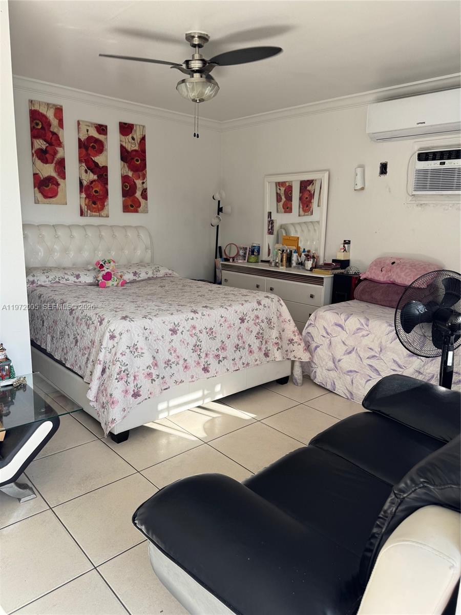 952 East 19th Street Hialeah, FL 33013 - Photo 9 of 13 a bedroom with a bed and wall painting