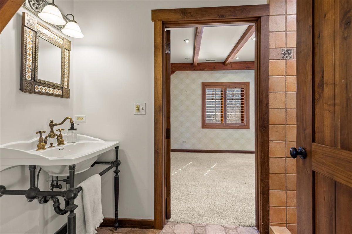 236 Steeplechase Road Barrington Hills, IL 60010 - Photo 30 of 69 a bathroom with a sink a mirror a vanity and window