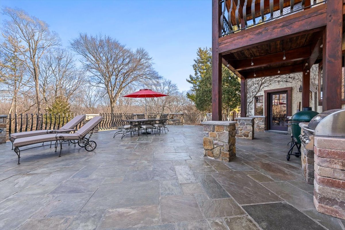 236 Steeplechase Road Barrington Hills, IL 60010 - Photo 54 of 69 a view of a patio with a table and chairs under an umbrella
