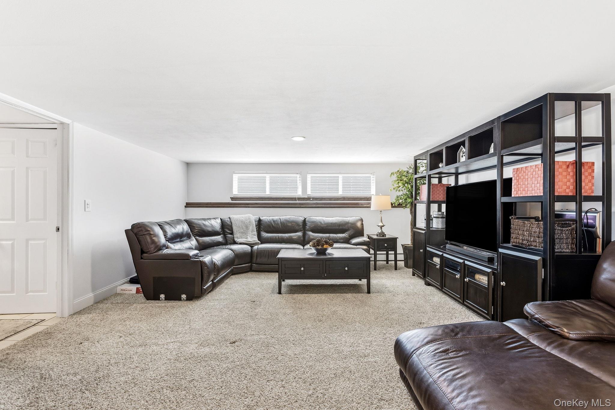 56 Tanager Road Mahopac, NY 10541 - Photo 20 of 30 a living room with furniture and a flat screen tv