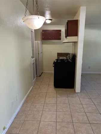 a living room with stainless steel appliances kitchen island granite countertop furniture a refrigerator and a fireplace