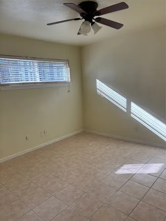 an empty room with a ceiling fan