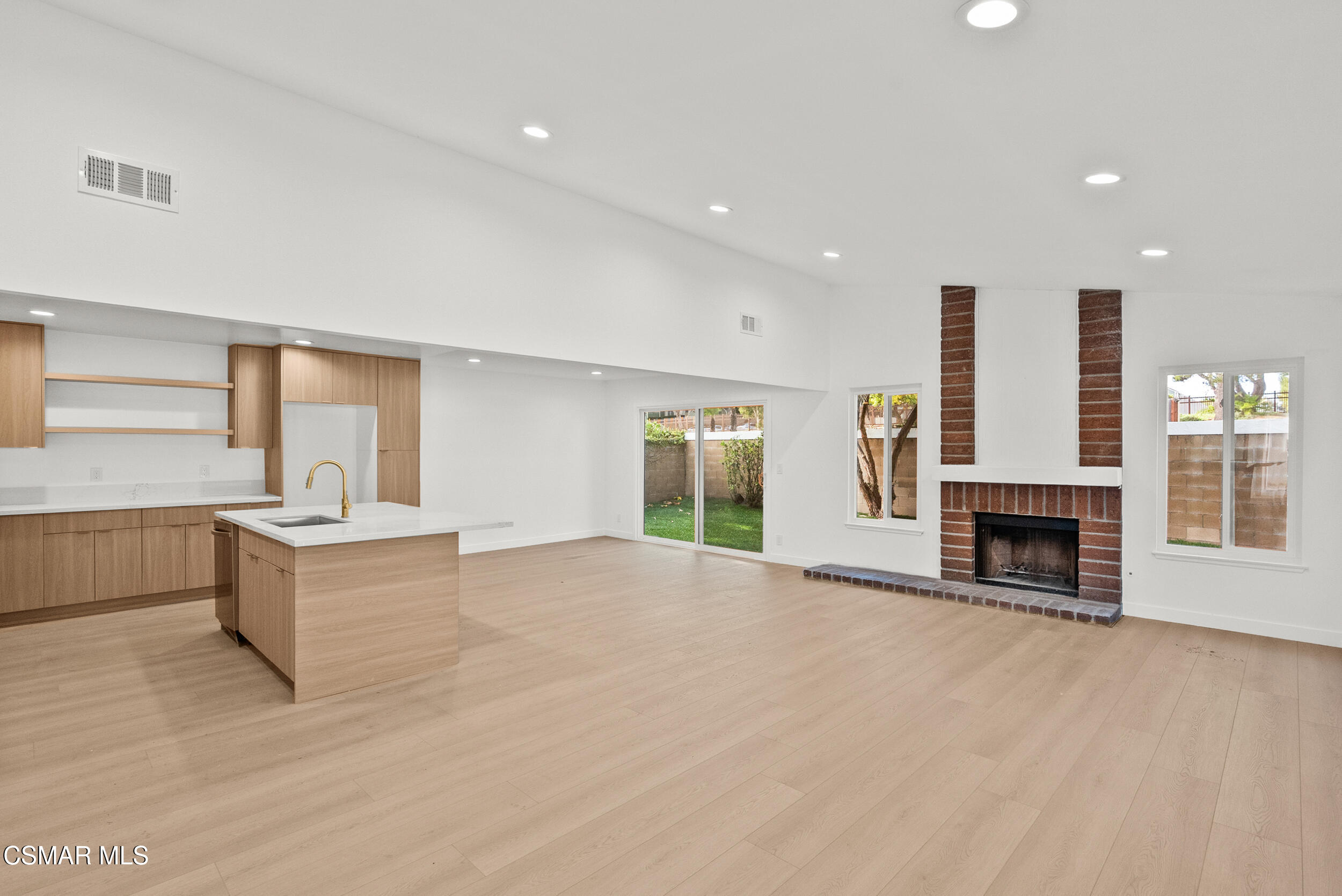 201 Village Road Port Hueneme, CA 93041 - Photo 7 of 21 a large white kitchen with granite countertop a stove and a sink with granite countertops