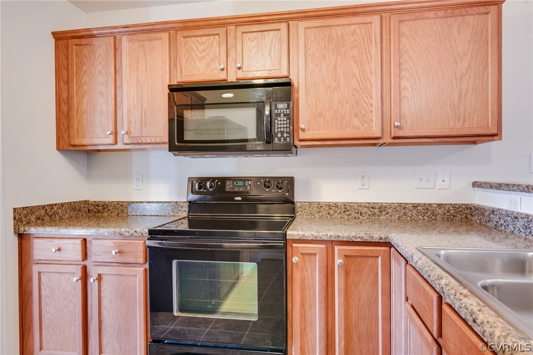 3931 Hazelnut Branch Road Midlothian, VA 23112 - Photo 21 of 34 a kitchen with granite countertop wood cabinets and a stove top oven