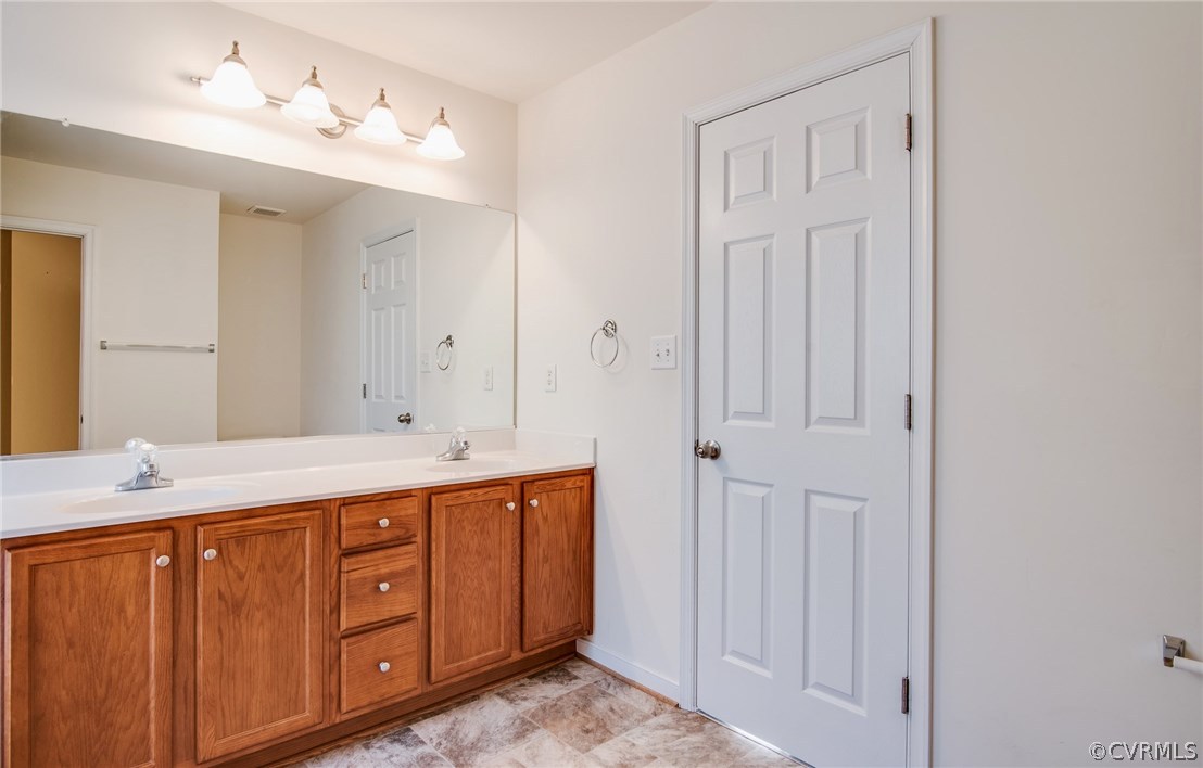 3931 Hazelnut Branch Road Midlothian, VA 23112 - Photo 26 of 34 a spacious bathroom with a double vanity sink and a mirror