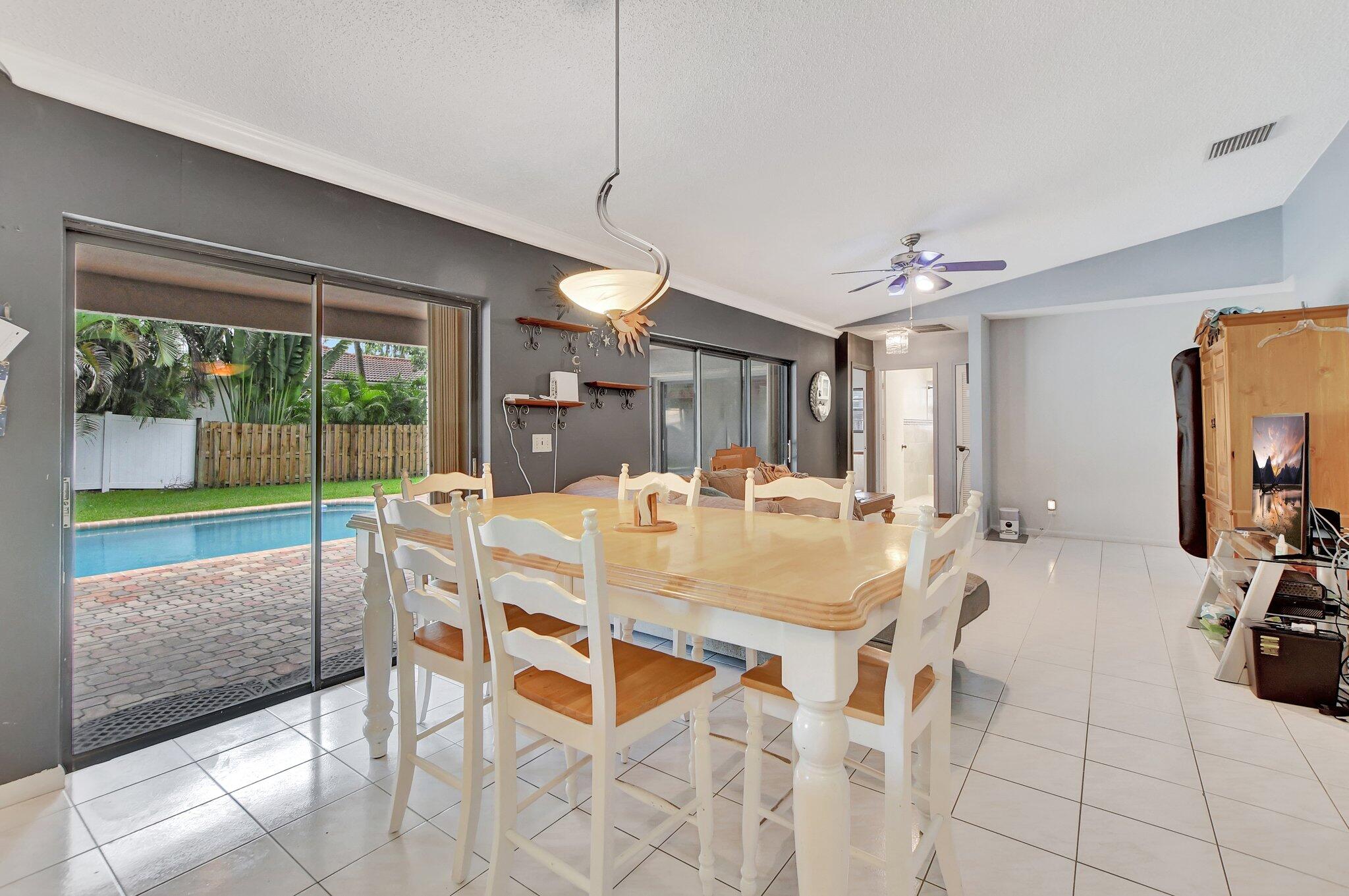 1398 Southwest 17th Street Boca Raton, FL 33486 - Photo 11 of 41 a view of a dining room with furniture and a floor to ceiling window