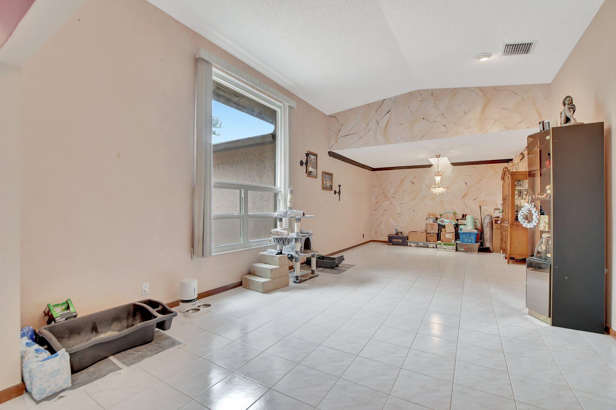 1398 Southwest 17th Street Boca Raton, FL 33486 - Photo 17 of 41 a room with gym equipment and a refrigerator