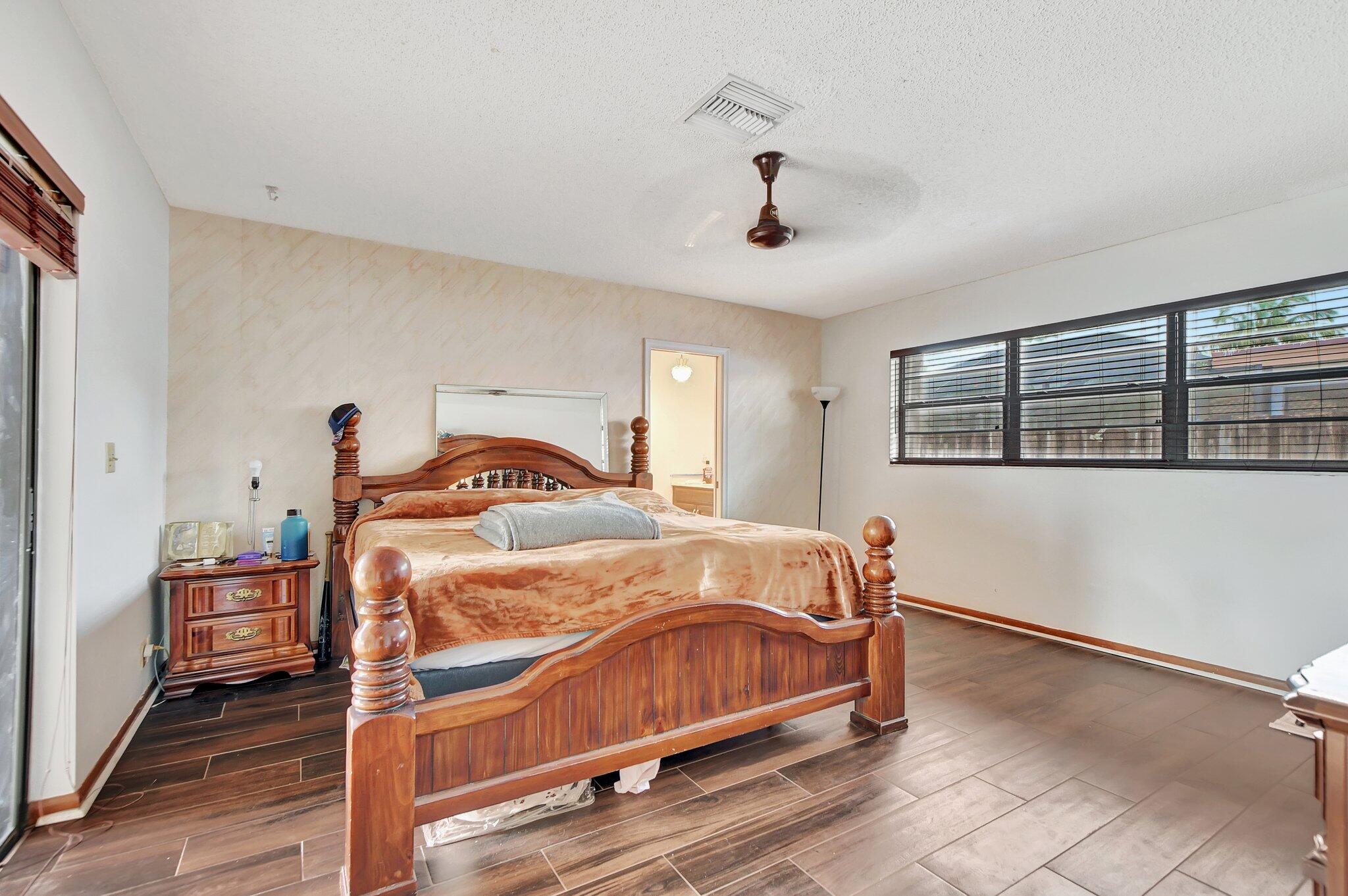 1398 Southwest 17th Street Boca Raton, FL 33486 - Photo 19 of 41 a bedroom with a bed and window
