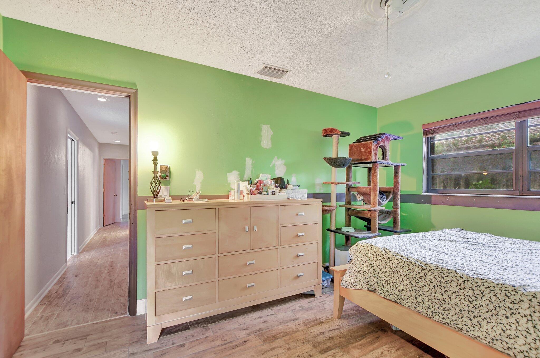 1398 Southwest 17th Street Boca Raton, FL 33486 - Photo 24 of 41 a bedroom with a bed and a dresser
