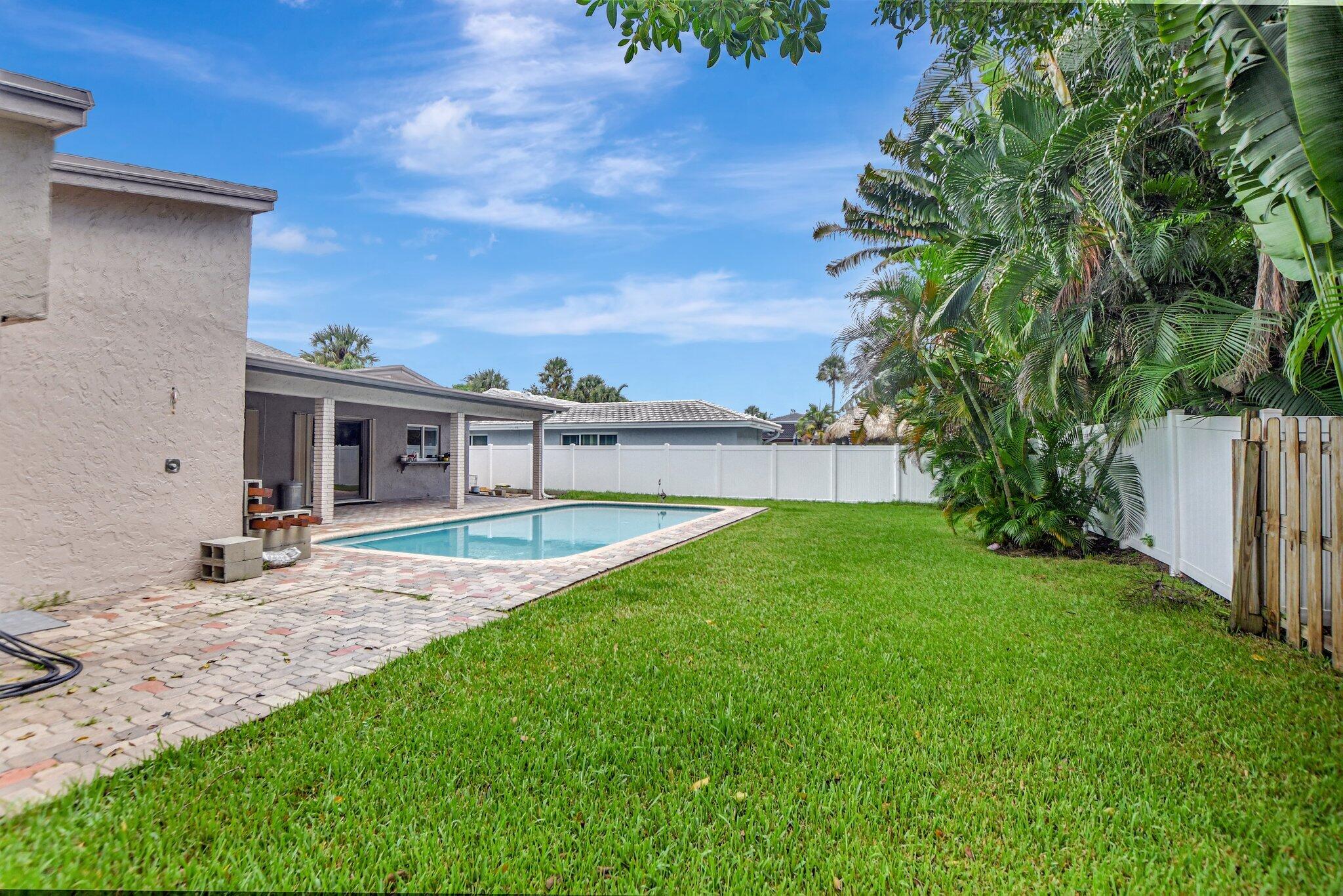 1398 Southwest 17th Street Boca Raton, FL 33486 - Photo 36 of 41 a view of a backyard with plants and a small yard