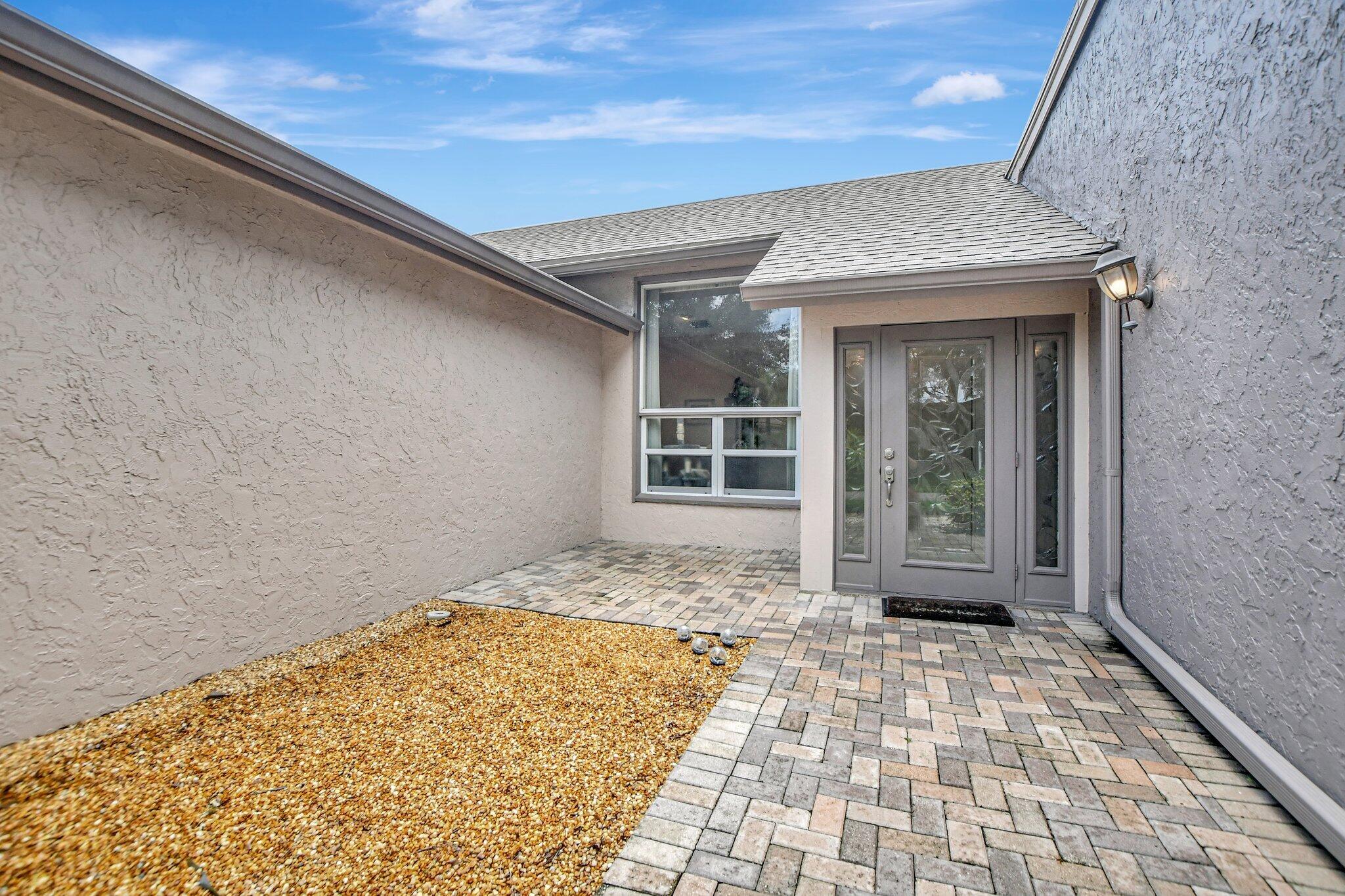 1398 Southwest 17th Street Boca Raton, FL 33486 - Photo 7 of 41 a view of a brick house with a large window