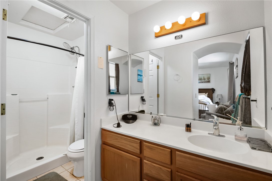 3668 North Neptune Road Golden Valley, AZ 86413 - Photo 32 of 38 The bathroom features a vanity with a single sink, a large mirror, and a shower with a toilet