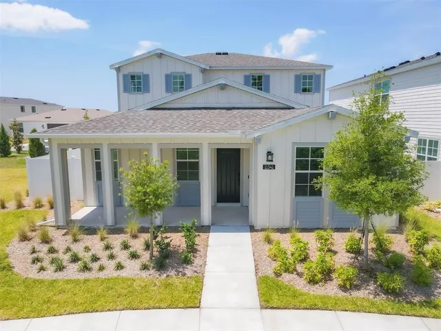 a front view of a house with a garden