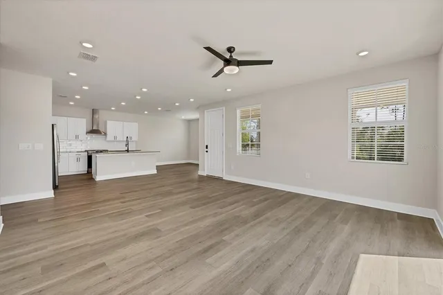 a kitchen with kitchen island granite countertop a sink stainless steel appliances and refrigerator