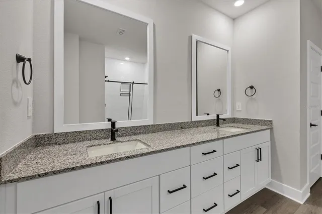 an empty room with a window and ceiling fan