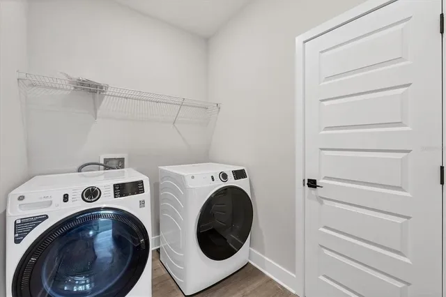 a sign board with buildings in the background