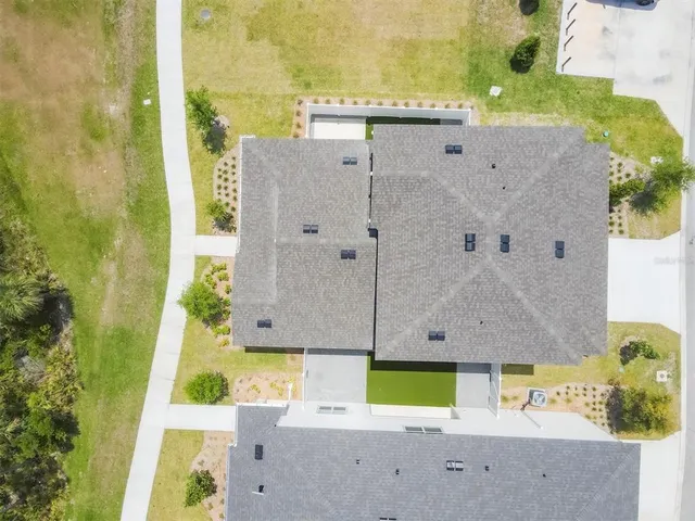 a front view of a house with swimming pool garden and outdoor seating