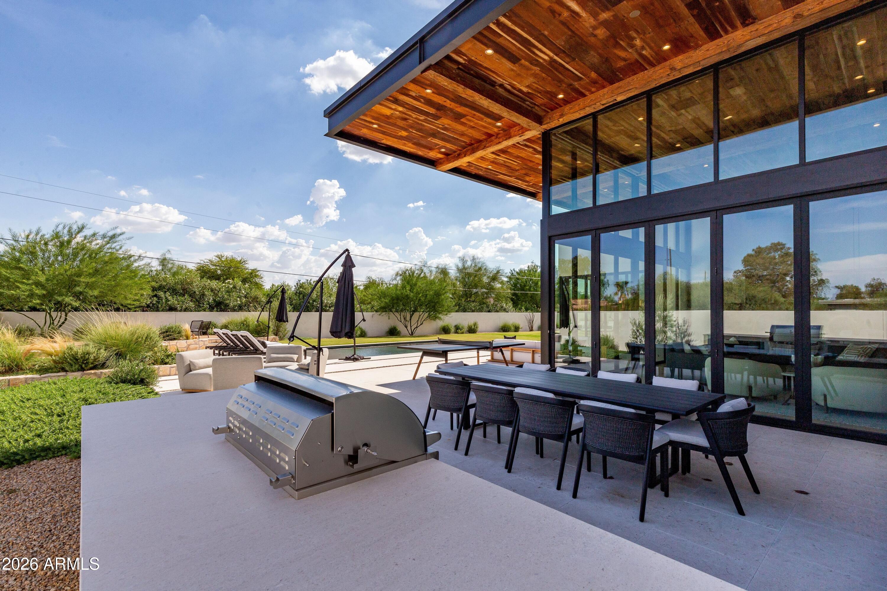 8307 East Gary Road Scottsdale, AZ 85260 - Photo 28 of 34 a view of a patio with a dining table and chairs