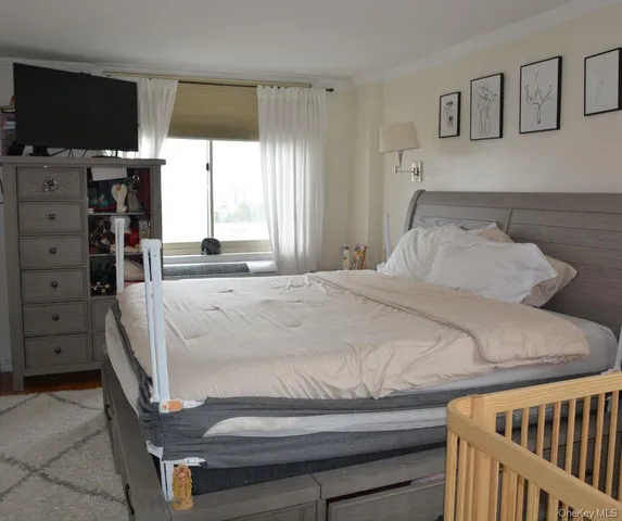 a bedroom with a bed and a flat screen tv
