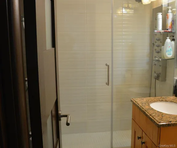 a bathroom with a granite countertop sink and a mirror