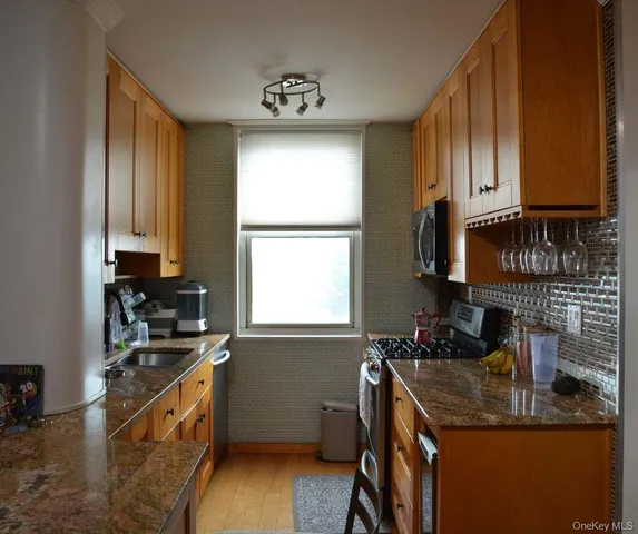 a kitchen with a sink stove top oven and cabinets