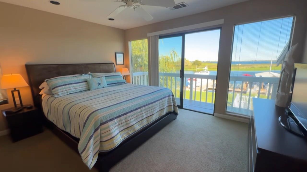 3777 Willow Road Bethel Island, CA 94511 - Photo 13 of 32 Bedroom with access to outside, dark colored carpet, and ceiling fan