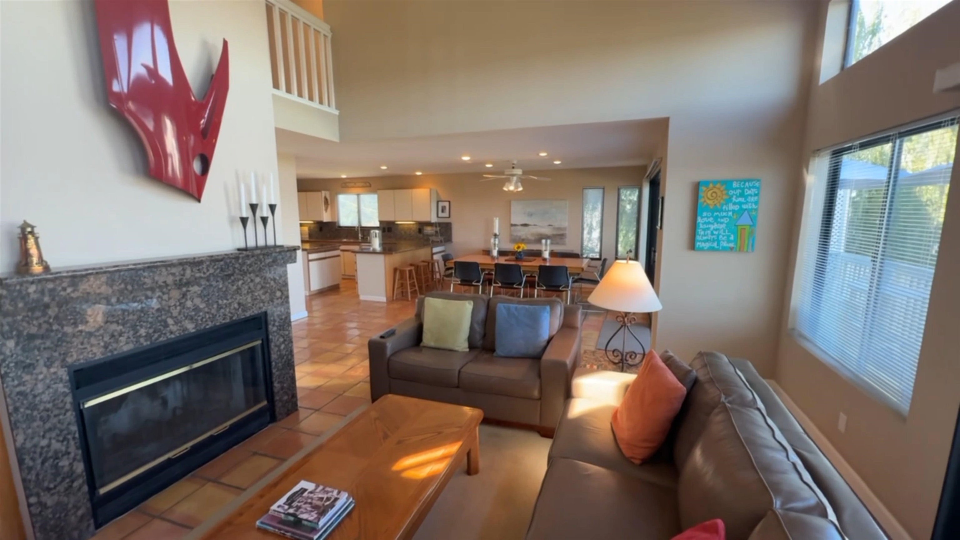 3777 Willow Road Bethel Island, CA 94511 - Photo 26 of 32 Living area featuring a tiled fireplace, ceiling fan, light tile patterned floors, and a high ceiling