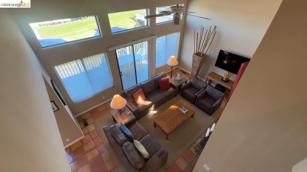 3777 Willow Road Bethel Island, CA 94511 - Photo 27 of 34 Living area featuring a high ceiling, tile patterned flooring, and a ceiling fan