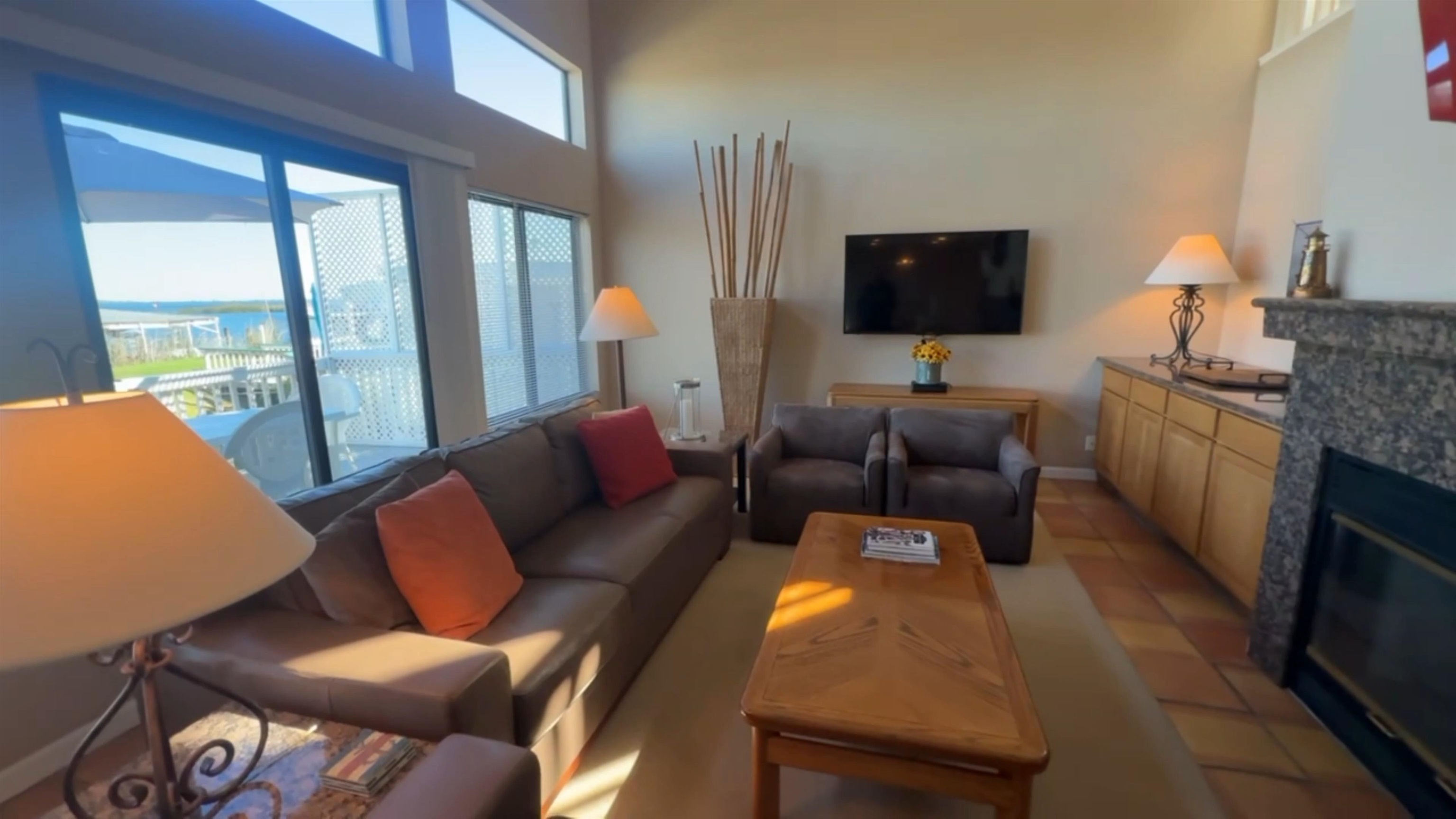 3777 Willow Road Bethel Island, CA 94511 - Photo 29 of 32 Living room with a high ceiling, a stone fireplace, and light tile patterned floors
