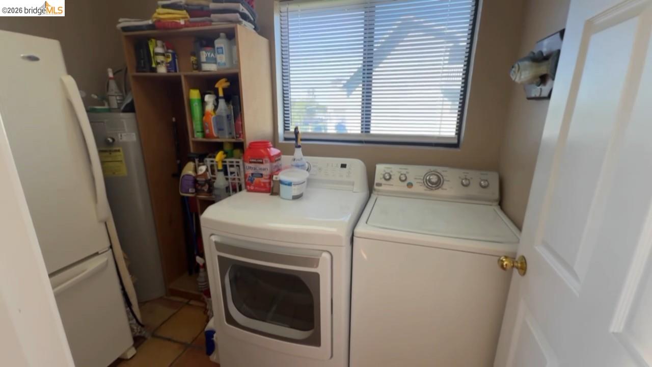 3777 Willow Road Bethel Island, CA 94511 - Photo 29 of 34 Laundry room with light tile patterned floors, independent washer and dryer, and water heater