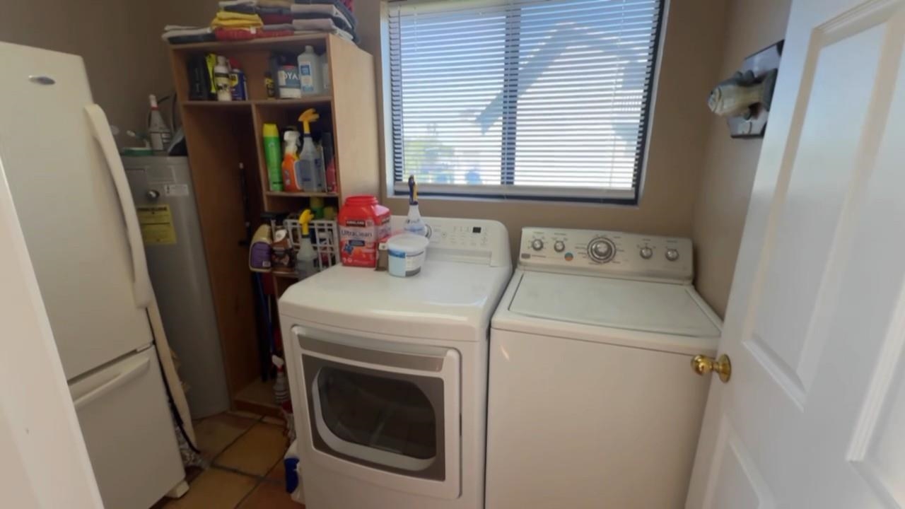 3777 Willow Road Bethel Island, CA 94511 - Photo 30 of 32 Laundry room with light tile patterned floors, independent washer and dryer, and water heater