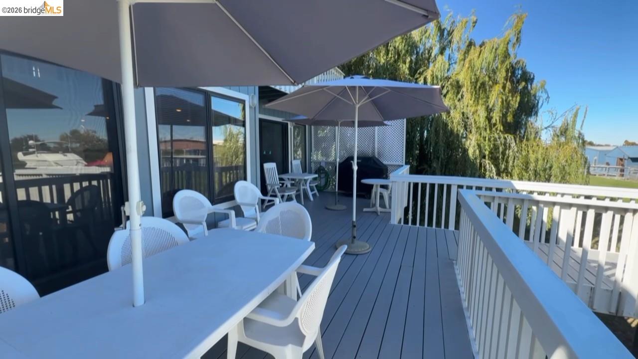 3777 Willow Road Bethel Island, CA 94511 - Photo 9 of 34 Wooden terrace with outdoor dining space and a grill