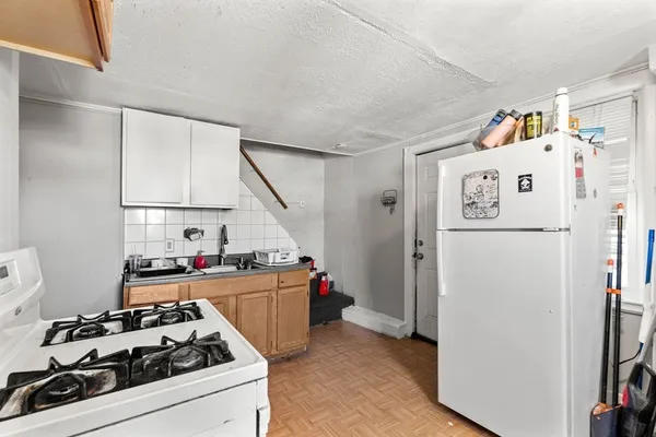 a white refrigerator freezer sitting inside of a kitchen
