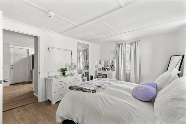 a bedroom with a bed and a dresser