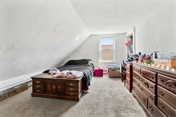 a bedroom with bed and a window
